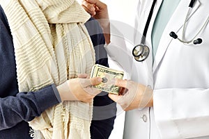 Health insurance concept, Patient paying doctor for medical service with money dollar banknote.
