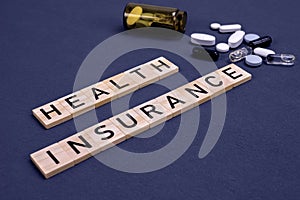 Health insurance concept with pills on gray background