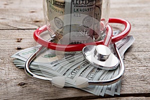 health insurance concept - stethoscope over the money