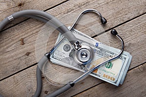 health insurance concept - stethoscope over the money