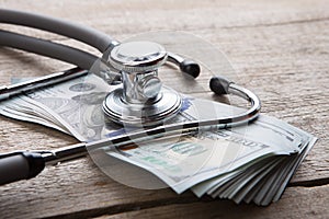 health insurance concept - stethoscope over the money