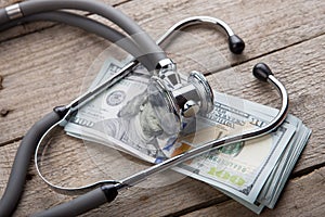 health insurance concept - stethoscope over the money