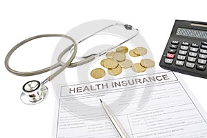 Health insurance form with coins and stethoscope