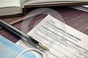 health insurance form with pen on wooden background