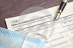 health insurance form with pen on wooden background