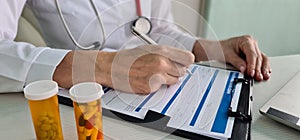 Health insurance payment form and pills on medical table