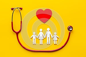 Health and medical care concept. Family figure with heart