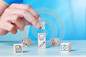 Health and Medical Plan Concept : Hand arranging wood block stacking with icon healthcare medical.