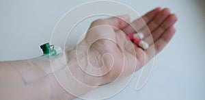 Health and medicine concept.Pills and pharmaceuticals. Colored capsules in hand on a white background