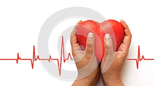 Health, medicine, people and cardiology concept - close up of hand with cardiogram on small red heart