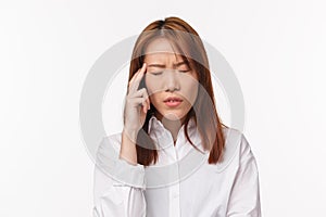Health, midicine and people concept. Close-up portrait of tired and dizzy young asian woman suffering headache, close