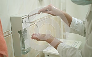 Health occupation worker washing her hands