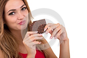 Health, people, food and beauty concept - Lovely smiling teenage girl eating chocolate