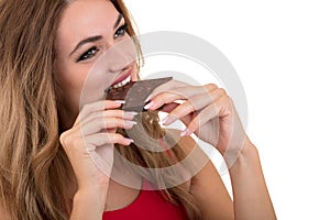 Health, people, food and beauty concept - Lovely smiling teenage girl eating chocolate