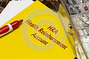 Health Reimbursement Account HRA, the text is written in red letters on a yellow sheet