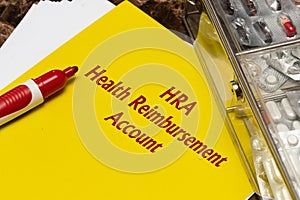 Health Reimbursement Account HRA, the text is written in red letters on a yellow sheet photo