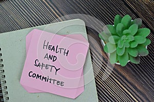 Health and Safety Committee write on sticky notes isolated on Wooden Table