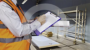 Health and safety official in a high visibility vest inspecting a construction site