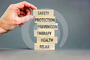 Health and safety symbol. Concept words Safety Protection Prevention Therapy Health Relax on wooden blocks on a beautiful grey
