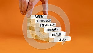 Health and safety symbol. Concept words Safety Protection Prevention Therapy Health Relax on wooden blocks on a beautiful orange