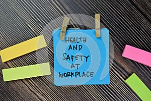 Health and Safety At Workplace write on sticky notes isolated on Wooden Table