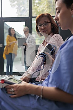 Health specialist measuring hypertension on tonometer