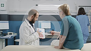 Health specialist showing cardiology illustration on digital tablet