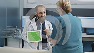 Health specialist showing tablet with horizontal green screen
