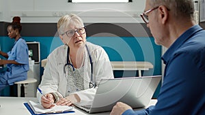 Health specialist taking notes at checkup examination