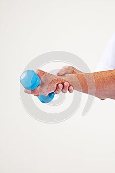 Health and sport. Mature woman exercising with dumbbell