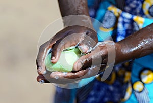 Health Symbol when African Girl Washes Her Hands Strongly with Soap and Sanitizer to avoid contacting Virus