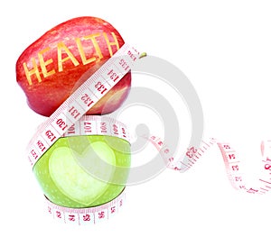 Health text and Heart shape on apple with white background, measuring tape wrapped around.