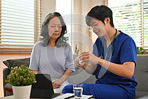 Health visitor explaining medicine dosage to senior patient. Elderly healthcare and Home health care service concept