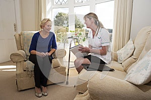 Health visitor on a home visit with elderly lady