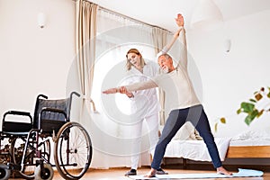 Health visitor and senior man during home visit.