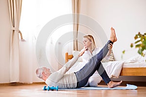 Health visitor and senior man during home visit.