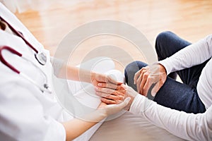 Health visitor and a senior man during home visit.