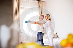 Health visitor and senior man during home visit.