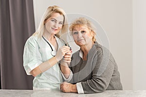 Health visitor and a senior woman during home visit.