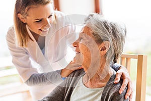 Health visitor and a senior woman during home visit.