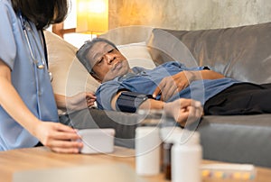 Health visitor and a senior woman during home visit.Worried senior man talking to her general practitioner visiting her at home