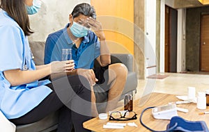 Health visitor and a senior woman during home visit.Worried senior man talking to her general practitioner visiting her at home