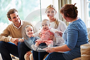 Health Visitor Talking To Family With Young Baby