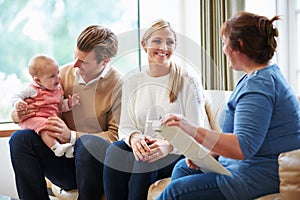 Health Visitor Talking To Family With Young Baby photo