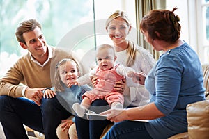 Health Visitor Talking To Family With Young Baby photo