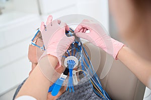 Health worker removes the electrodes from the patient head