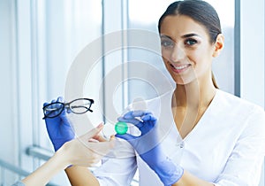 Health. Young Girl Holds Contact Lens In Hands. Portrait of a Beautiful Woman with Green Eyes and Contact Lenses