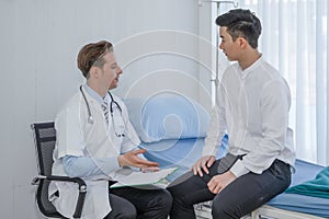 Healthcare background of caucasian male medical doctor examining asian patient on bed in hospital