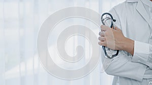 Healthcare background of doctor hand holding stethoscope on white bright background