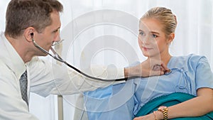 Healthcare background of physical doctor examining patient with stethoscope at hospital